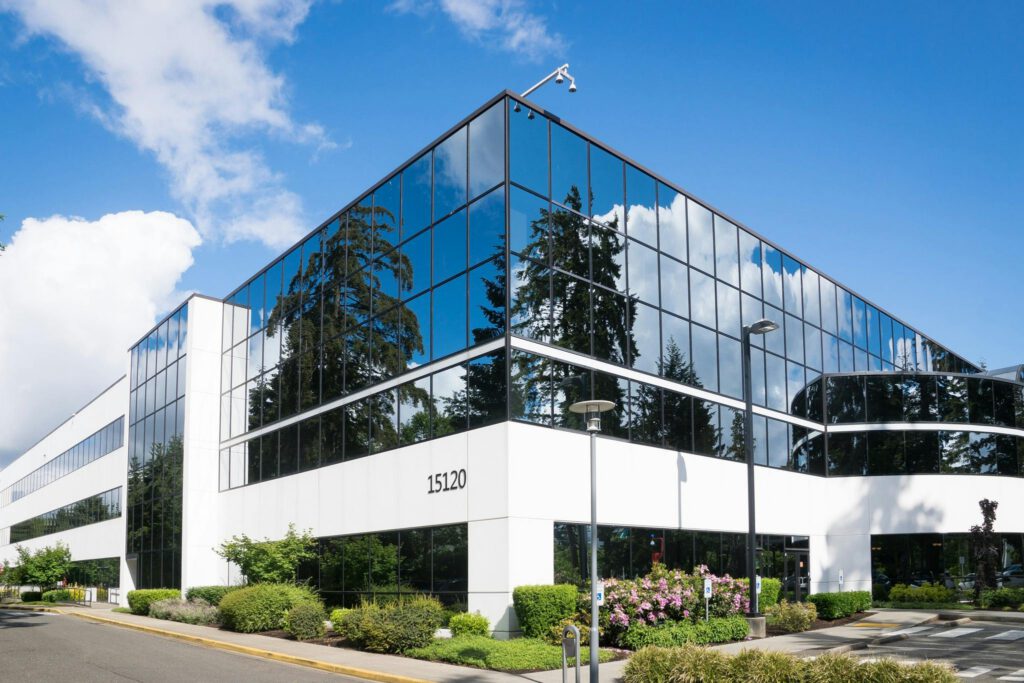 service-3 Contemporary office building in Redmond with reflective glass and lush greenery, captured on a sunny day.