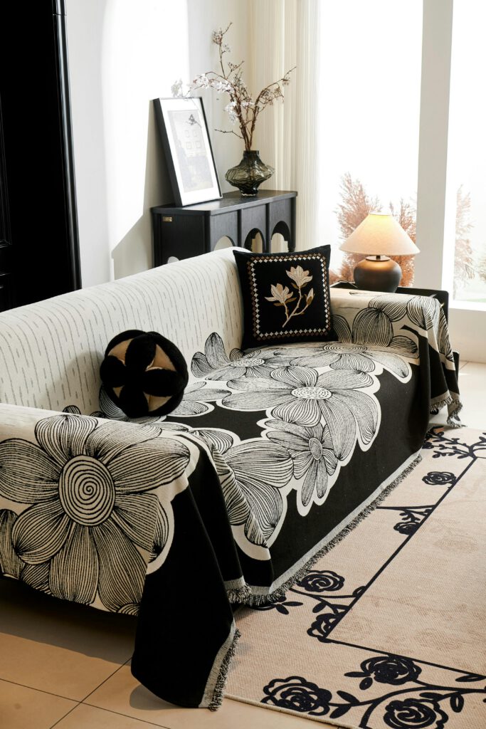 A cozy living room setup with a decorative floral sofa cover and stylish decor.