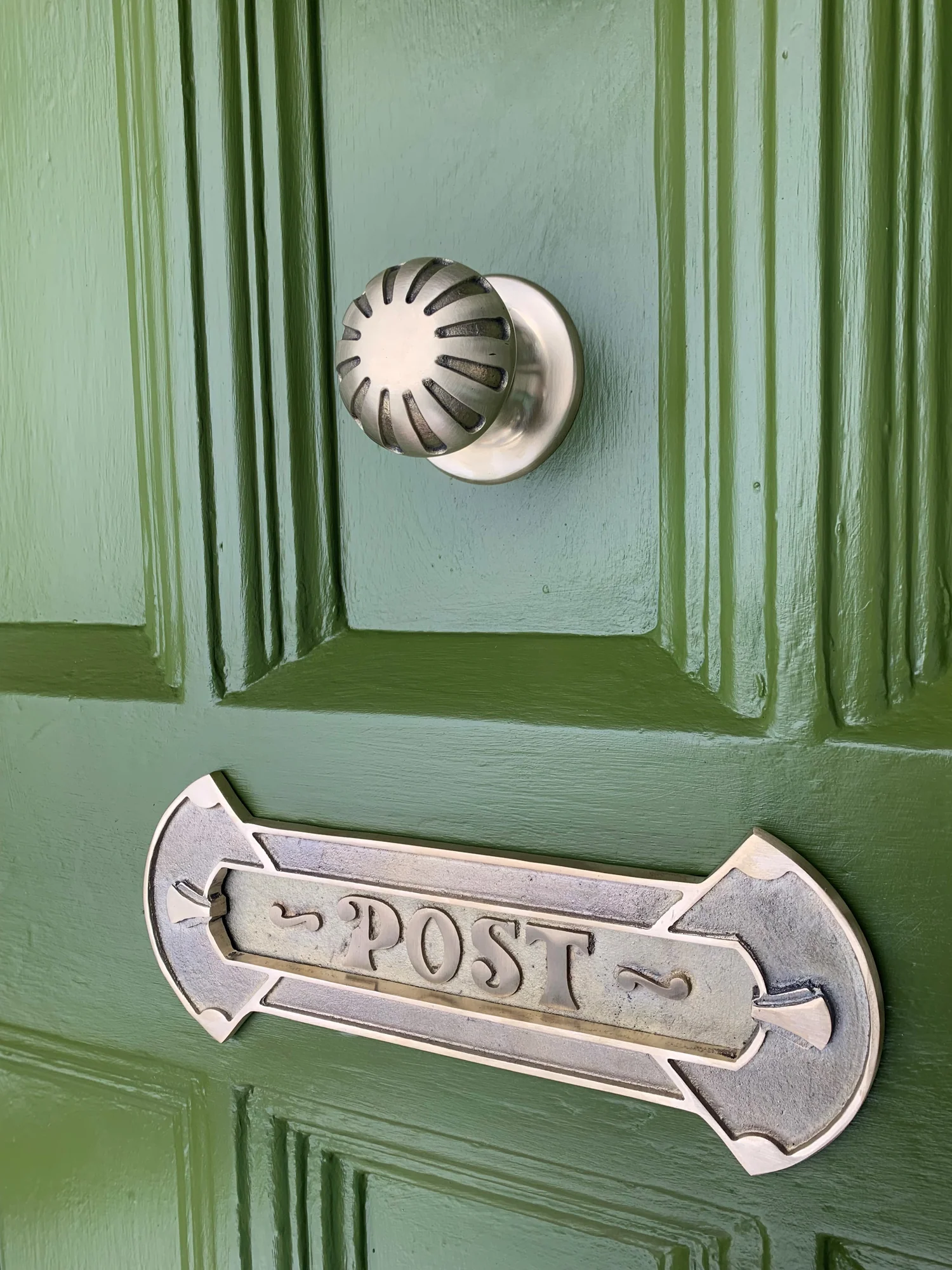 green door with letter box